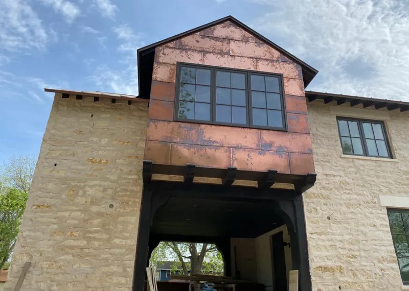 Copper metal panel facade on a stone building for Metal Roof Coating in Ellenton
